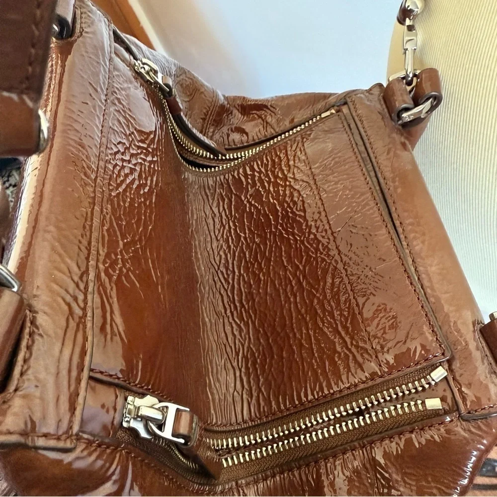 Tory Burch half moon patent leather brown purse with crossbody strap